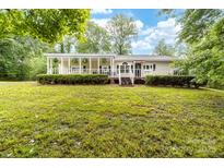 Charming ranch-style home featuring a lovely porch and lush, green landscaping at 3716 Hamilton Dr, Gastonia, NC 28052