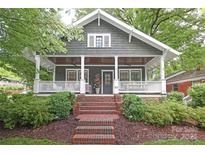Charming home with a welcoming front porch, manicured landscaping, and classic details at 501 E Tremont Ave, Charlotte, NC 28203