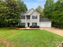 Charming two-story home with classic curb appeal, lush lawn and mature trees at 524 N Portman Ln, Fort Mill, SC 29708