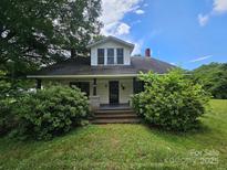 Charming home with a covered front porch and lush landscaping at 562 W Wilson Ave, Mooresville, NC 28115