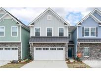 Charming two-story home with a brick and siding exterior and an attached two-car garage at 7416 Hartsfield Dr, Lancaster, SC 29720