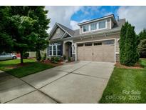 Charming home with a two-car garage, manicured lawn, and beautifully landscaped front yard at 8818 Artesa Mill Ln, Charlotte, NC 28214