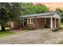 Charming brick home featuring a covered parking area and inviting front entrance at 16 Green St, York, SC 29745