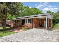 Charming brick home featuring a covered carport and updated landscaping at 16 Green St, York, SC 29745