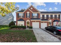 Charming two-story brick home with a two-car garage and manicured front lawn at 165 N Arcadian Way, Mooresville, NC 28117