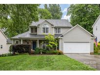 Charming two-story home with a well-manicured lawn and attached two-car garage at 17318 Cambridge Grove Dr, Huntersville, NC 28078