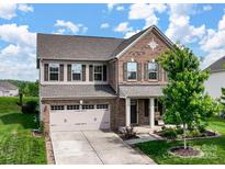 Charming two-story brick home featuring a two-car garage and well-manicured front lawn at 2178 Stone Pile Sw Dr, Concord, NC 28025
