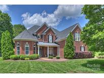 Beautiful two-story brick home with a well-manicured lawn and lovely landscaping at 2300 Lord Anson Dr, Waxhaw, NC 28173