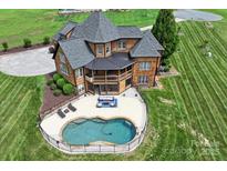 Stunning aerial view of backyard featuring a large in-ground pool and manicured lawn at 270 Sandhills Ct, Mooresville, NC 28115