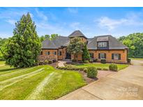 Charming home with manicured lawn, stone accents, and a welcoming walkway at 270 Sandhills Ct, Mooresville, NC 28115