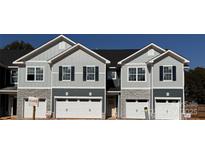 Modern townhome exterior featuring stone accents, vertical siding, and two-car garages at 4049 Port Richmond Ave # 10, Gastonia, NC 28056