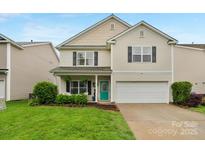 Charming two-story home featuring a well-manicured front lawn and a welcoming teal front door at 507 Galesburg Dr, Monroe, NC 28110
