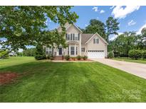 Charming two-story home with manicured lawn, attached two-car garage and classic colonial-style shutters and trim at 6504 Sybil Ct, Indian Trail, NC 28079