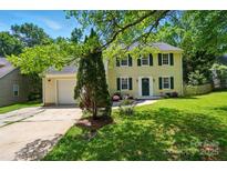 Charming two-story home featuring a well-manicured lawn and a welcoming front porch at 8014 Sherington Way, Charlotte, NC 28227
