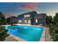 Inviting backyard with a sparkling pool, patio area, and lush landscaping at 837 Tyne Dr, Fort Mill, SC 29715