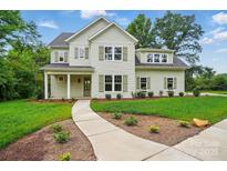 Charming two-story home with manicured lawn, beautiful landscaping, and inviting walkway at 9315 Simpson Rd, Waxhaw, NC 28173