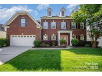 Charming two-story brick home with a well-manicured lawn and inviting front porch at 10515 Greenhead View Rd, Charlotte, NC 28262