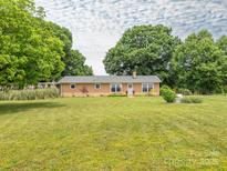 Charming brick home featuring a well-manicured front yard and inviting curb appeal at 1325 Marshville Olive Branch Rd, Marshville, NC 28103