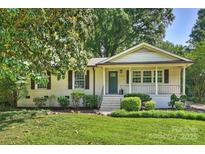 Charming brick home with a welcoming front porch and beautifully landscaped front yard at 1522 Barberry Ct, Charlotte, NC 28211