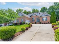 Charming brick home with a well-manicured lawn and driveway at 1643 Essex Hall Dr, Rock Hill, SC 29730