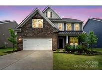 Beautiful two-story home with brick and siding, lush lawn, and two-car garage at 17812 New Mark Ave, Charlotte, NC 28278
