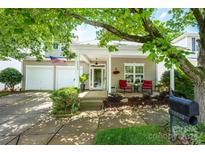 Charming home featuring a covered porch with cozy seating and a two-car garage at 19539 Denae Lynn Dr, Cornelius, NC 28031