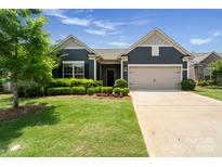 Charming single-Gathering home with well-manicured lawn and an attached two-car garage at 2329 Delaney Dr, Fort Mill, SC 29715