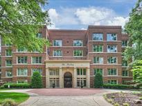 Charming brick building with manicured landscaping and grand entrance, The Sterling, offers classic elegance at 2445 Selwyn Ave # 104, Charlotte, NC 28209