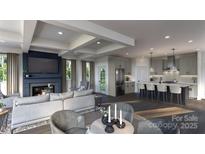 Open floor plan with fireplace, coffered ceilings, and modern kitchen featuring stainless steel appliances and bar seating at 305 S Gardner Ave, Charlotte, NC 28208
