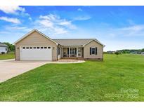 Charming single-story home features a two-car garage, inviting front porch, and lush green lawn at 3645 Kimber Ln, Sherrills Ford, NC 28673