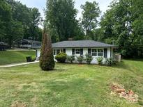 Charming single-story home with a well-manicured lawn and classic black shutters at 518 Westside Cir, China Grove, NC 28023