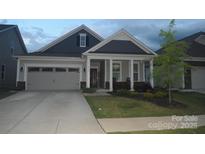 Charming home featuring a well-maintained front yard, covered porch, and a two-car attached garage at 813 Latrobe Dr # 365, Iron Station, NC 28080