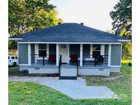 Charming single-story home features a cozy front porch and a well-manicured lawn with mature trees at 918 8Th St # 5, Lancaster, SC 29720