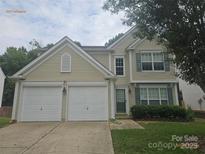 Charming home featuring a two-car garage, manicured lawn, and traditional architecture at 9237 Bellegarde Dr, Charlotte, NC 28277