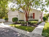 Charming home with a well-manicured lawn and an attached garage, offering both curb appeal and convenience at 9360 Meadowmont View Dr, Charlotte, NC 28269