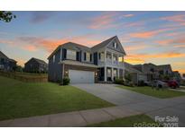 Stunning two-story home with a welcoming porch and a well-manicured lawn at 1001 Linn Cv, Waxhaw, NC 28173