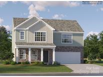 Charming two-story home with stone accents, attached two-car garage, and well-manicured lawn at 1102 Old Trade St, Edgemoor, SC 29712