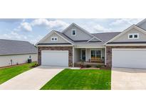 Charming home featuring a stone and siding exterior with a well-manicured front yard and a two-car garage at 122 A Deer Brook Dr # A, Shelby, NC 28150