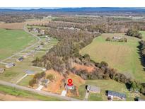 An aerial view of a single-Gathering home surrounded by lush greenery and farmland in a serene countryside setting at 1244 Bob Falls Rd, Shelby, NC 28150