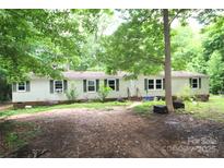 Modest single-story home featuring a lush, tree-filled yard and vinyl siding at 1320 Smith Woods Dr, Hickory Grove, SC 29717