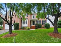 Charming brick home featuring manicured lawn and a classic facade with decorative shutters at 138 Montibello Dr, Mooresville, NC 28117
