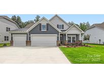 Charming two-story home with a three car garage, beautiful lawn, and manicured landscaping at 1528 Croydon St, Indian Land, SC 29707