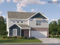 Charming two-story home featuring a stone-accented facade, a well-manicured lawn, and a welcoming two-car garage at 1615 Spring Lot Dr, Edgemoor, SC 29712