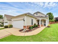 Charming single-story home featuring a well-manicured lawn, a two-car garage, and a welcoming front porch at 19106 Mallard Dr # 216, Fort Mill, SC 29707