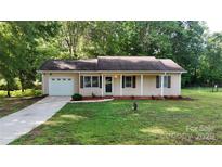 Charming single-story home with manicured lawn, attached garage, and inviting entrance at 2026 Willow Ridge St, Conover, NC 28613