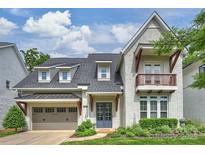 Charming home featuring neutral brick, balcony and inviting entrance with manicured landscaping at 2630 Mary Butler Way, Charlotte, NC 28226