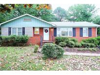 Charming single-story brick home featuring a well-maintained front yard and inviting entrance at 3016 Boston Ave, Charlotte, NC 28212