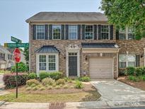 Charming brick townhome features a well-manicured front yard and an attached one car garage at 6505 Central Pacific Ave, Charlotte, NC 28210