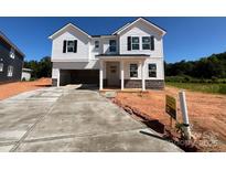 New two-story white home boasts a clean design and open garage, set against a blue sky at 1005 Cunningham Farm Dr, Indian Trail, NC 28079