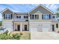 Charming townhome featuring a symmetrical facade, white siding, and well-manicured landscaping at 1066 Mclain Rd # 14, Kannapolis, NC 28083
